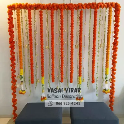 Here is a classic and vibrant backdrop we designed, perfect for a Haldi ceremony or a naming ceremony. We used strings of fresh orange marigold flowers to create a simple yet beautiful photo corner, bringing a touch of tradition to the event.