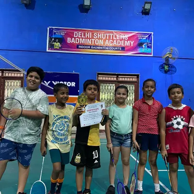A group of our junior players posing with a trophy after a local tournament. We are proud to support and celebrate the success of our young athletes.