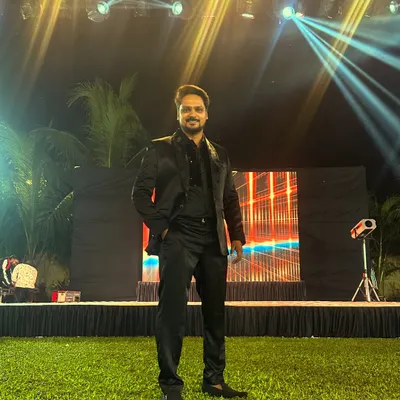 A solo shot from an outdoor event, ready to take the stage. I bring the same level of energy and professionalism whether the event is in a grand ballroom or an open lawn.