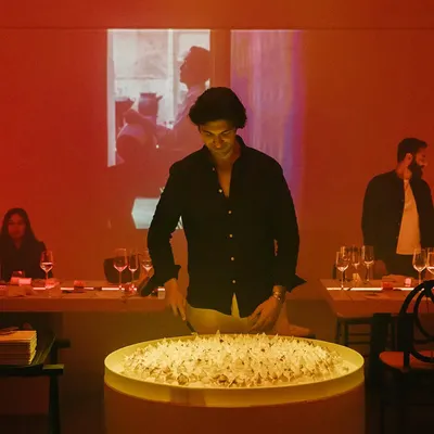 The guest of honor at his 30th birthday party, standing by an oversized cake we created. The brief was to "keep it fun," and we started with a dessert that made a big statement.