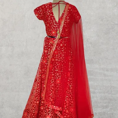 This rich red lehenga is a showstopper, designed for weddings and grand celebrations. The all-over embroidery and classic silhouette are handcrafted for a look of timeless elegance.