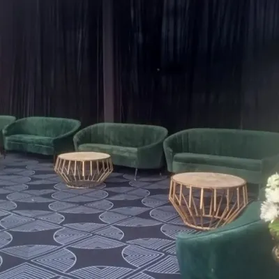 I offer premium furniture rentals, including these luxurious green velvet sofas and geometric gold coffee tables. This type of setup is perfect for creating an exclusive VIP lounge at a corporate event or conference.