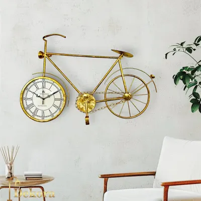 Our creative cycle wall clock in a golden finish, a playful yet elegant piece of metal art that incorporates a functional clock.