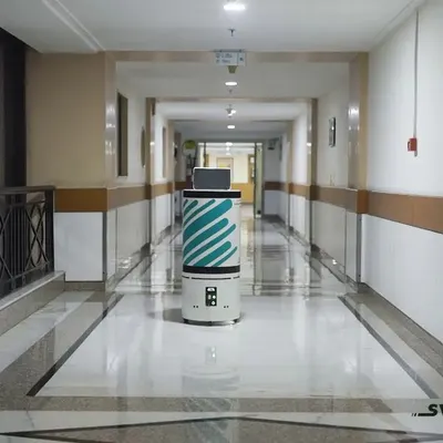 A screengrab from the Swift Robotics product video, showing the autonomous medical delivery robot navigating a hospital corridor. The shot is clean and centered to focus on the product's capability.