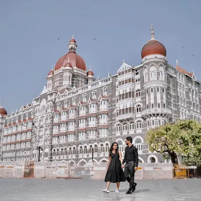 A wide shot that captures the grandeur of the Taj Mahal Palace Hotel. I position the couple walking in the foreground to create a photo that feels both epic and personal.