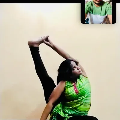 Another example from an online session focusing on body opening. I am watching my student's form closely to help her achieve the correct alignment in this challenging seated pose, ensuring she gets the full benefit of the stretch.