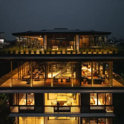An evening view of the upper levels of 'The Light House', showcasing the glass-encased entertainment areas and rooftop deck that offer panoramic views of the Nagpur cityscape.