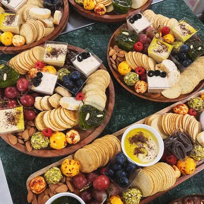 A beautiful overhead view of my luxury grazing platters, ready for a celebration. I love creating these abundant spreads, filled with a variety of cheeses, dips, crackers, and fresh fruits to make any gathering feel special.