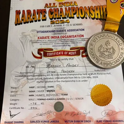 The official certificate of merit and silver medal awarded to Harshit Pandey for his performance in the senior category at the All India Karate Championship.