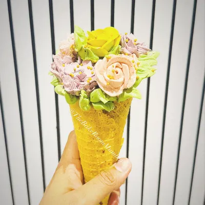 My signature Floral Conesicle, an edible bouquet of buttercream flowers with a cake pop inside. It's a unique dessert that's as beautiful to look at as it is delicious to eat.