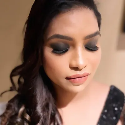 A detailed close-up of the classic smokey eye I created for this bride's cocktail night. The deep black shadow is expertly blended for a dramatic yet sophisticated effect, paired with a soft nude lip.