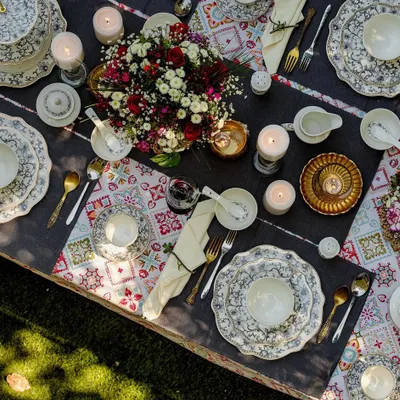 A stunning overhead shot of a fully dressed dinner table featuring Vigneto's crockery. This image captures the beauty of a complete tablescape, perfect for showcasing an entire dinnerware collection in an aspirational setting.