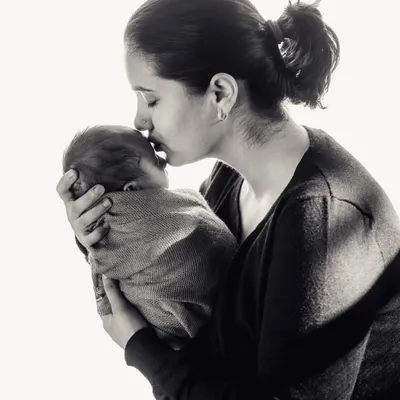 There is nothing as pure as a mother's love. This black and white photo captures a tender kiss, a timeless moment between a mother and her newborn that they will both treasure forever.