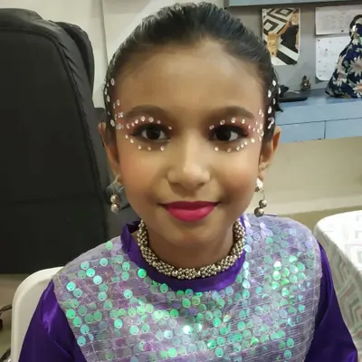 A close-up of this creative dance makeup for a young performer. I used face gems and bright lipstick to create a look that sparkles and stands out on stage.