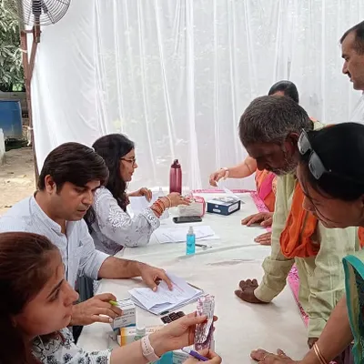 Continuing my father's vision, we organized a free medical camp for the community. Here, our team is busy with vital checks, diet consultations, and medicine distribution for over 350 people.
