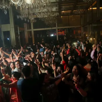 The energy of a packed dance floor at a wedding reception is electric. I love capturing these wide shots that show everyone celebrating and having an amazing time together.