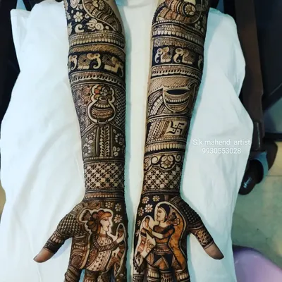 Getting ready for Navratri? I can create designs with festive figures like these Dandiya dancers. This full-arm mehendi also includes traditional elements like a kalash, swastika, and peacock.