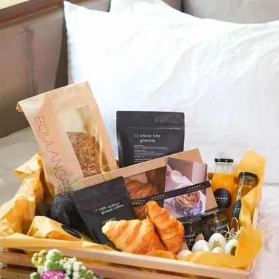 Surprise Mom with our luxurious breakfast-in-bed hamper this Mother's Day. This beautiful wooden crate is filled with fresh croissants, our wheat-free granola, artisanal coffee, fresh juice, and other gourmet treats to start her day perfectly.