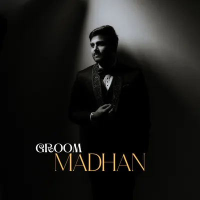 A classic, dramatic portrait of the groom in his reception tuxedo. The single light source creates a moody, cinematic effect that highlights his sharp style.