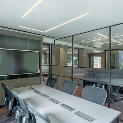 This modern conference room is designed for transparency and connection. I used glass partitions to maintain an open feel while providing acoustic privacy, and integrated linear LED lighting to create a bright, professional atmosphere conducive to collaboration.