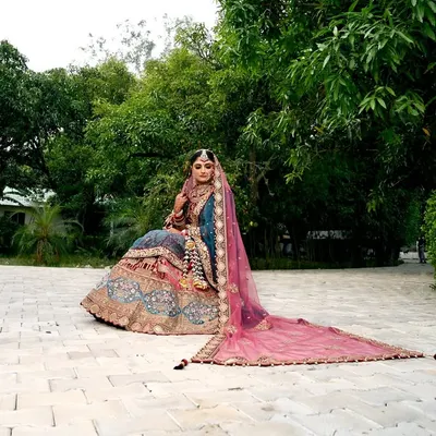 A breathtaking bridal portrait in Chamba, with the long pink veil of the lehenga spread out beautifully. I love using natural landscapes to create grand and elegant shots like this.