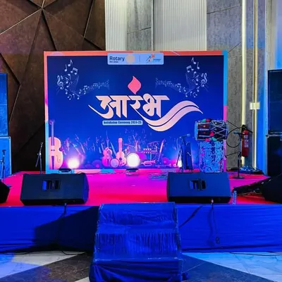 A full view of the stage we set up for the "Aarambh" event by Rotary Club Bhiwadi. The setup includes a branded backdrop, professional speakers, and stage monitors.