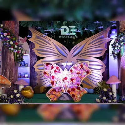 I love bringing a child's birthday theme to life. For this celebration, I created an enchanted forest with a magnificent butterfly centerpiece, using a mix of floral arrangements and custom-built structures to make the fantasy feel real.