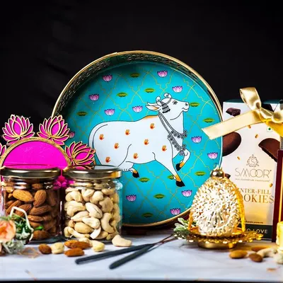 Our signature Diwali hamper, professionally shot to showcase its elegance. This festive arrangement includes a decorative tray, jars of premium dry fruits, gourmet cookies, and a traditional diya, perfect for corporate and personal gifting.