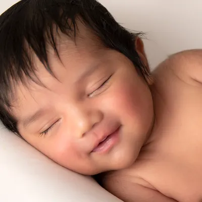 The purest smile, captured in a simple, clean portrait. My focus during newborn sessions is on your baby's natural beauty and peaceful expressions.