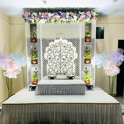 This is one of my favorite home Ganpati setups, featuring a clean, modern aesthetic. The design is centered around a Tree of Life Jaali panel and includes a custom platform, creating a serene and beautiful space for worship.