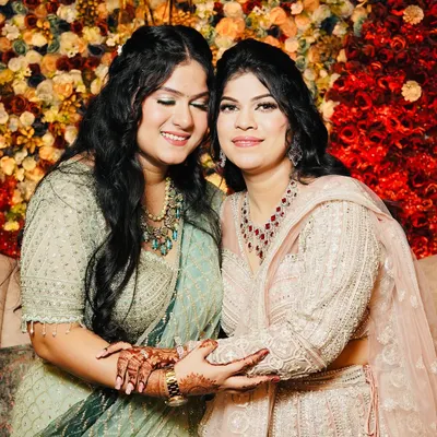 A beautiful moment between two sisters I styled for a wedding. I gave them complementary looks with soft glam makeup that highlighted their features and matched their pastel outfits.