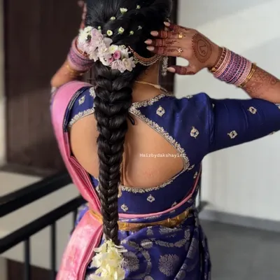 A beautiful fishtail braid adorned with fresh flowers. This hairstyle is a modern twist on the traditional braid and pairs wonderfully with silk sarees.