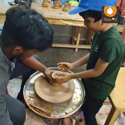 A student gets his first feel of the pottery wheel. With guidance from our instructor, he is learning how to center the clay, a fundamental skill in pottery that requires focus and calm hands.