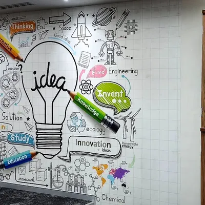 This motivational mural with an 'idea' lightbulb and creative doodles is perfect for a startup or innovation hub. I ensure even complex graphics are installed flawlessly next to office furniture.