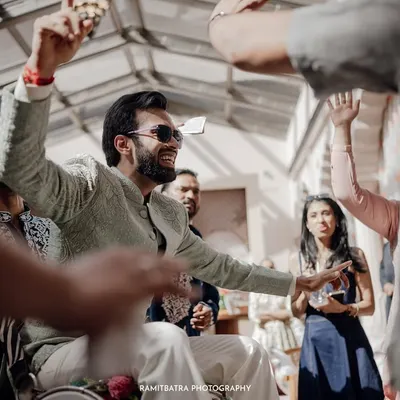 The groom makes a grand, high-energy entrance at his Sangeet, showering everyone with excitement.