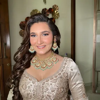 Unfiltered glam for an engagement or sangeet. This look features a dewy base, soft smokey eyes, and voluminous curls, perfect for a night of celebration.