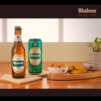 A clean product shot featuring the Mahou Clasica bottle and can. Paired with almonds and savory snacks, this image is ideal for e-commerce listings and menu photography.