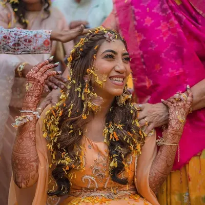 Haldi and mehendi, a perfect combination. A candid moment of pure joy as my bride Akshata is showered with flower petals during her haldi ceremony.