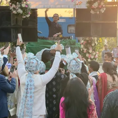 The groom's crew with their hands in the air, celebrating on the move. My DJ on Wheels setup ensures the baraat is an unforgettable, high-energy procession.