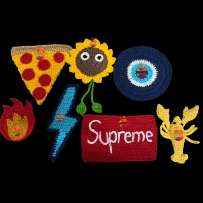 A collection of my custom-made crochet patches, also known as appliques. You can see a pizza slice, a sunflower, an evil eye, a lightning bolt, and even a lobster, ready to be sewn onto any item.