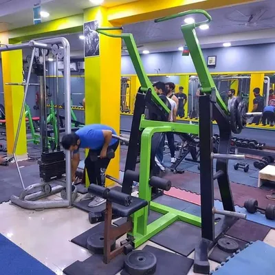 A look at our members during a busy session. You can see the lat pulldown machine in the foreground and other members using the free weights and cable machines in the background.