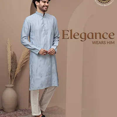 Elegance wears him. This light blue textured kurta, paired with white trousers, is a perfect example of understated style. The fabric has a subtle self-design that adds a touch of sophistication.
