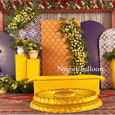 This is a complete Haldi ceremony stage I designed. I combined modern geometric panels in purple and orange with traditional yellow seating and lush floral arrangements to create a vibrant, photo-ready backdrop for the main event.