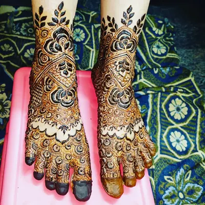 Your bridal look isn't complete without mehendi on your feet. I designed this piece with full coverage for the top of the feet, featuring bold floral and leaf patterns that climb up the ankles.