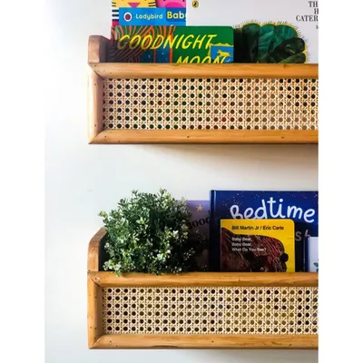 These custom-made cane and wood shelves are perfect for displaying your child's favorite books. The natural texture of the cane adds a beautiful, handcrafted element to the wall.