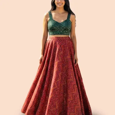 Celebrate in style with this stunning red lehenga, paired with a contrasting green sequined blouse. It's a perfect ensemble for a Dandiya night or any festive occasion, blending tradition with vibrant energy.