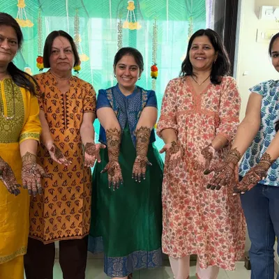 A group of happy clients showing off their party mehendi. It's so much fun getting henna done with your friends and family.