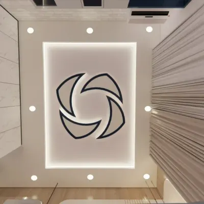 A worm's-eye view of a creative false ceiling design with a unique geometric cutout and backlighting.