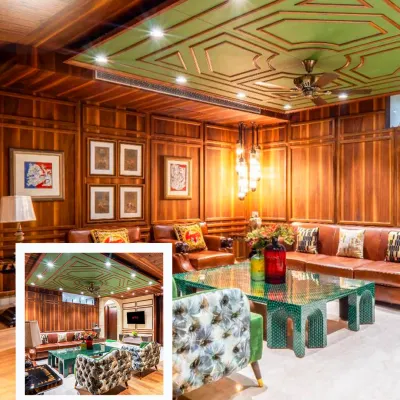 This living room is a great example of how I mix classic woodwork with bold, modern accents. The rich wood paneling provides warmth, while the patterned armchair and green table add a spark of personality and make for a great conversation starter.