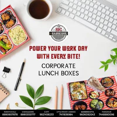 A bird's-eye view of our corporate lunch box, laid out on a work desk. It shows the variety packed inside, including biryani, starters, and sides, making for a perfect and productive workday meal.